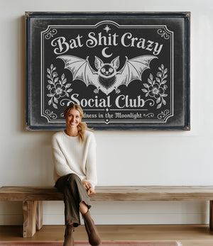 Bat Shit Crazy Social Club Sign Halloween wall art in a styled room