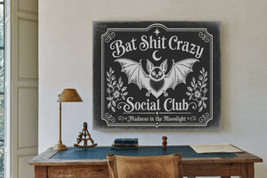Bat Shit Crazy Social Club Sign Halloween wall art in a styled room