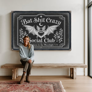 Bat Shit Crazy Social Club Sign Halloween wall art in a styled room