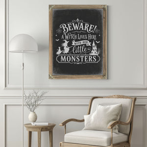 Beware A Witch Lives Here Sign Halloween wall art in a styled room