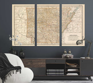 a living room with a couch and two maps on the wall