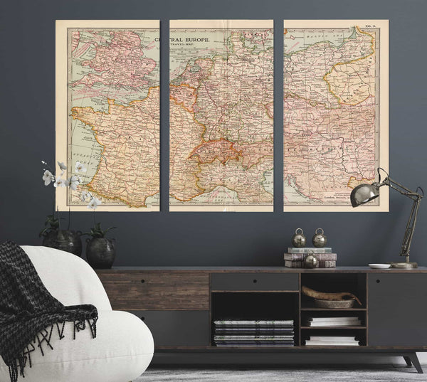 a living room with a couch and two maps on the wall