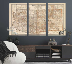 a living room with a couch and two maps on the wall